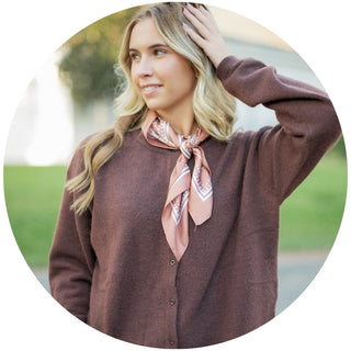 woman modeling a cream colored mock neck long sleeve sweater top