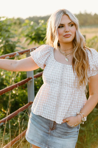 Beige and white gingham top with puff sleeve and smocked back.