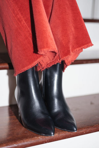 black vegan leather booties with a sleek pointed toe and sturdy block heel, front view