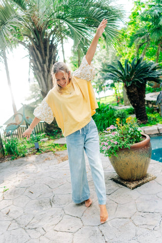Baggy yellow and white striped top with floral sleeves 
