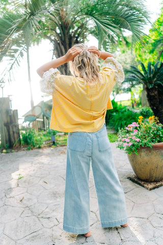 Light denim wide leg pants with white tie around waist. Sizes small-large 
