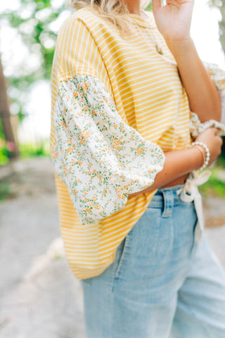 yellow and white baggy blouse with floral sleeves 