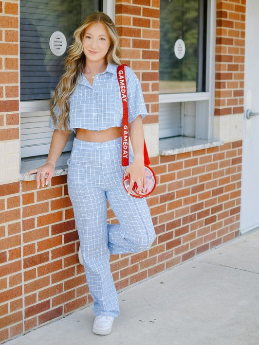 baby blue gingham plaid pant blouse set with red beaded gameday bag strap and red clear stadium approved handbag purse