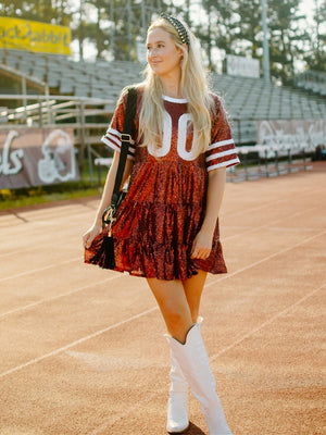 maroon red and white short sleeve sequin jersey tiered mini dress with white knee high cowgirl boots and black pearl headband