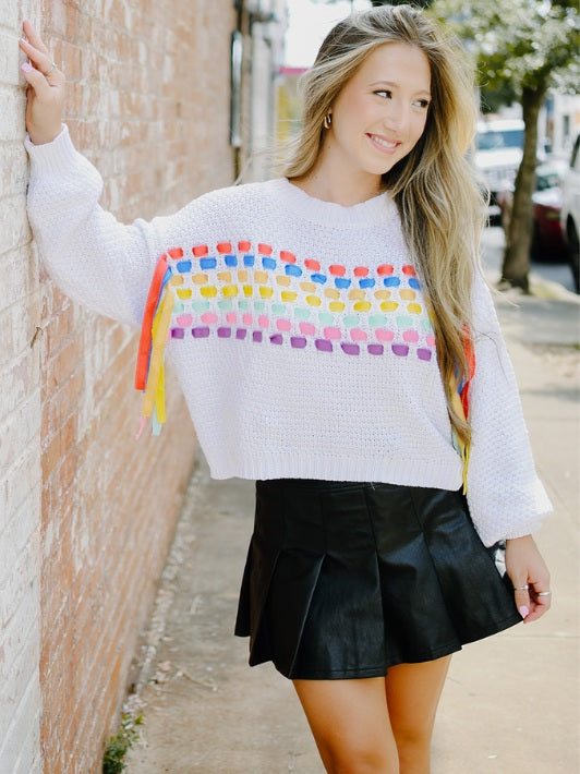 white rainbow ribbon long sleeve sweater with black vegan leather tennis skirt