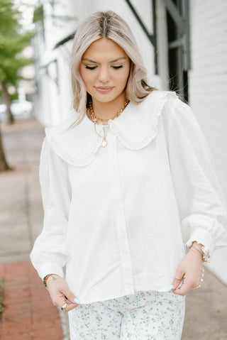 White buttoned peter pan collared long sleeve blouse.