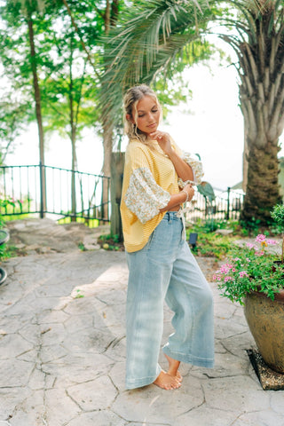 Light denim wide leg pants with white tie around waist. Sizes small-large 