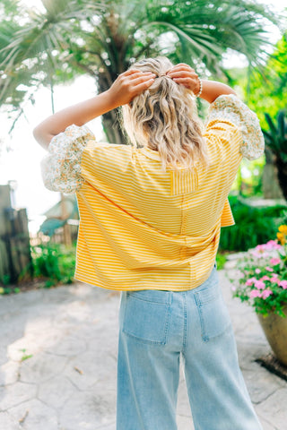 Flowy yellow and white striped top with floral sleeves 