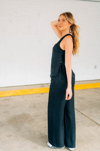 V neck button down vest with ties on side. Matching black pants 
