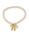 Pearl bracelet with gold heart and bow detailing. 