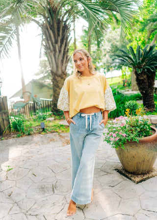 Light denim wide leg pants with white tie around waist. Sizes small-large 