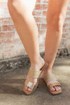 A metallic gold finish and a unique woven design sandal with a double strap and slip on style and a comfortable square toe