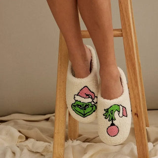 cream fuzzy closed toe slipper with green and pink Grinch design