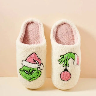 cream fuzzy closed toe slipper with green and pink Grinch design, top view