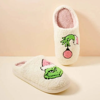 cream fuzzy closed toe slipper with green and pink Grinch design, side view