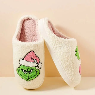 cream fuzzy closed toe slipper with green and pink Grinch design, inside and sole view