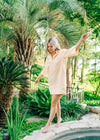 Orange and white striped dress with collar neckline. Sleeves are mid- length 