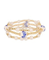 Gold elastic bracelet with pearl and porcelain detailing.