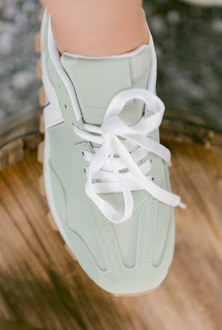 turquoise and white lace up sneakers with rounded toe and platform design, top view