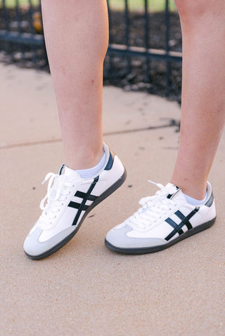 White and black low top sneaker with black and grey details