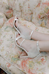 white sparkling, shimmery heels with a square toe design and a delicate ankle strap with unique bow back detail