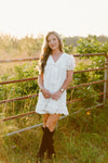 White V-neck bow dress with puff sleeves and lace trim detailing.