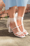 classic white hue and sparkling rhinestone detail heels with a lace up ankle and sturdy block heel