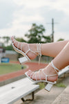 white low block heels with a chic square toe and tie up ankle straps 